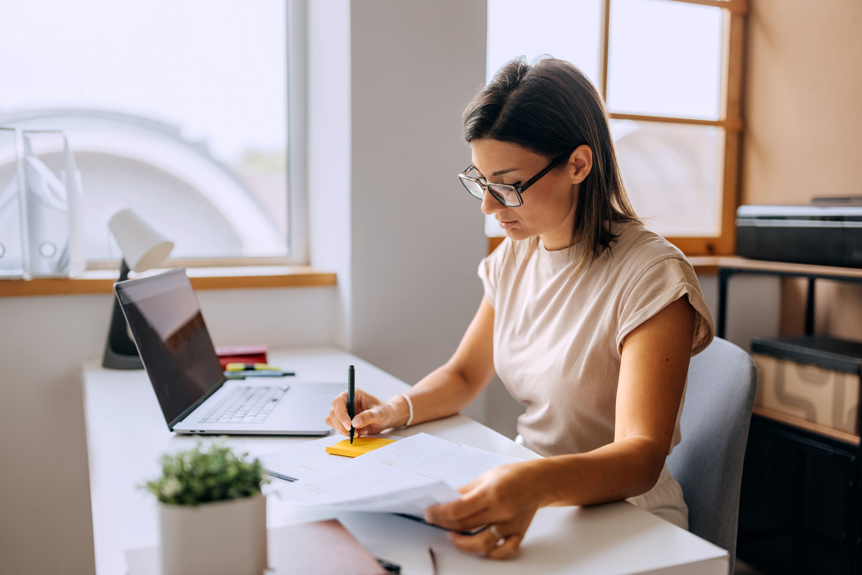Woman working at office, taking notes